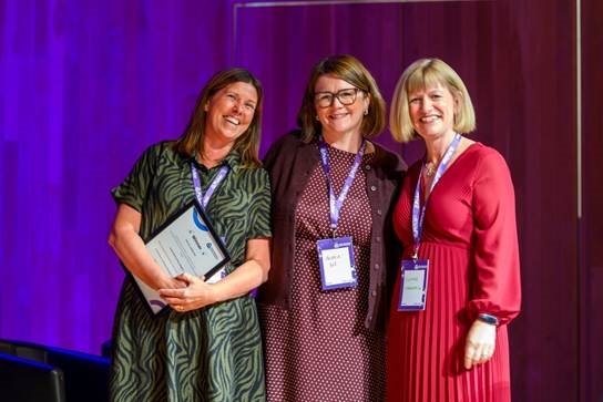 A group of women standing togetherAI-generated content may be incorrect.